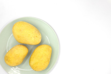 Tropical fruit mango top view photo on white background. Yellow mango served banner template with text place