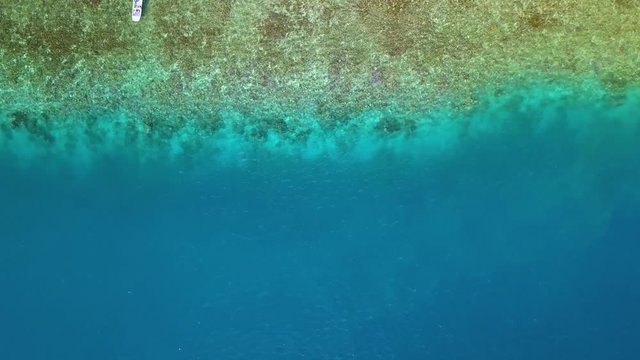 Bora Bora aerial footage from a drone of yacht boats sailing on blue ocean at Bora Bora island, Tahiti, French Polynesia, South Pacific Ocean

