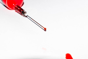 Medical syringe with blood isolated on white background for design