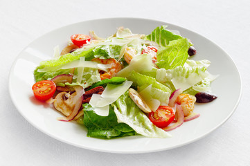 romaine salad with shrimps, champingons, tomatoes, olives, and onion dressed with modena vinegar and olive oil and sprinkled with parmesan