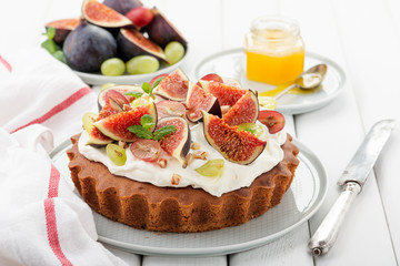 Delicious creamy tart cake with fresh figs and grape.