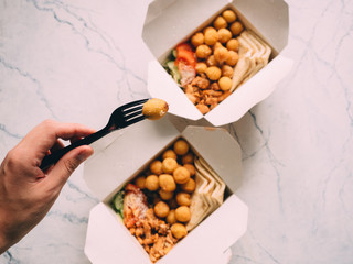open gyros with chicken, potato balls, pita and vegetables