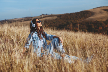 Young woman enjoys the sun in the meadow