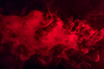 Colorful smoke on a black background of red and white colors. The concept of smoking. Beautiful...