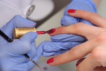 Professional manicure process in beauty salon.