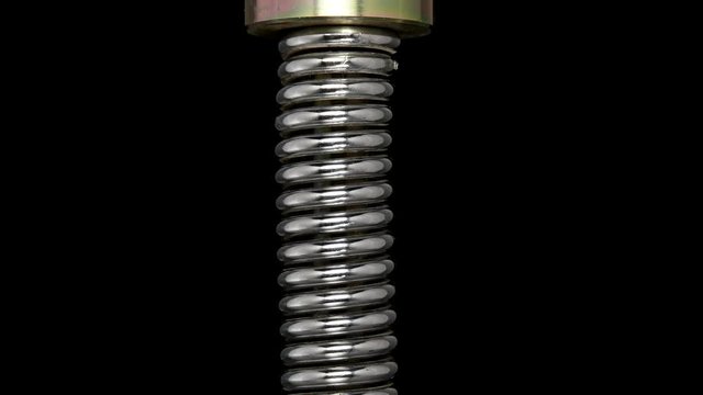 test of reliability of a spring, compression and decompression by a hydraulic press, close-up