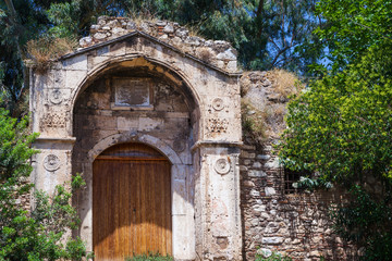 Fototapeta na wymiar Antique gates, doors. The entrance to the temple in Athens Greece