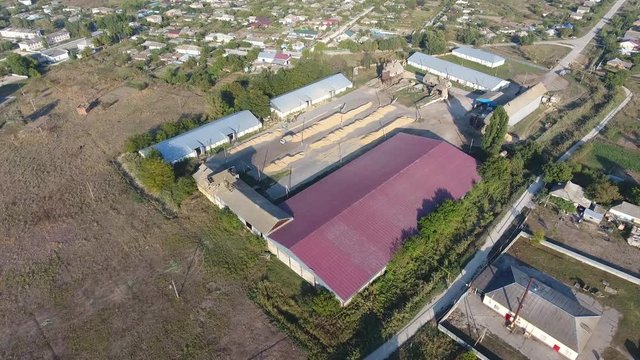 Hangar for storage of grain. A platform for drying and sintering grain. Harvested grain.