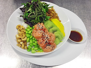 diced raw fish with fruits, nuts, vegetables and rice 