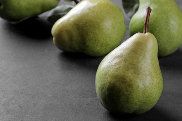 Fresh ripe pears closeup on a black background