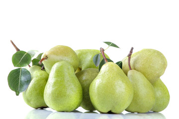 A lot of ripe fresh pears with leaves stacked in a pile on a white isolated background
