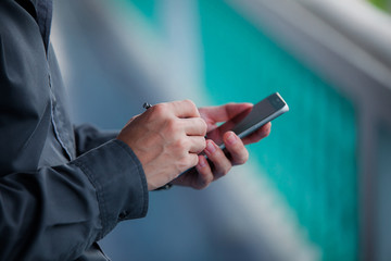 Close up of a man using mobile smart phone