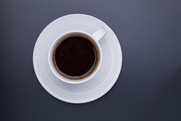 Cup of black coffee on table top view, flat lay, mock up. Cup of Black Coffee in White Ceramic Cup on plastic Tabletop
