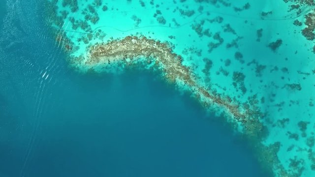 Aerial footage from a drone of blue lagoon and small islands at Bora Bora island, Tahiti, French Polynesia, South Pacific Ocean (Bora Bora Aerial)
