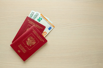 Russian passports and euro on table. Top view.