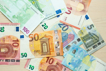 Euro banknotes of different denominations on the table