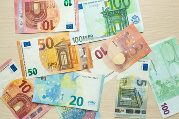 Euro banknotes of different denominations on the table