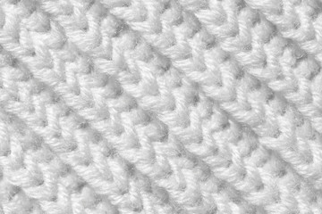 The background is white. The texture of the knitted fabric is made of woolen threads handmade.