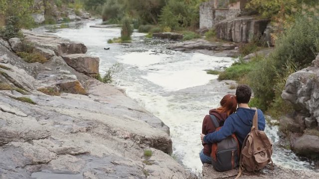 Young couple looking at natural canyon with view of the mountain river. Concept of travel.