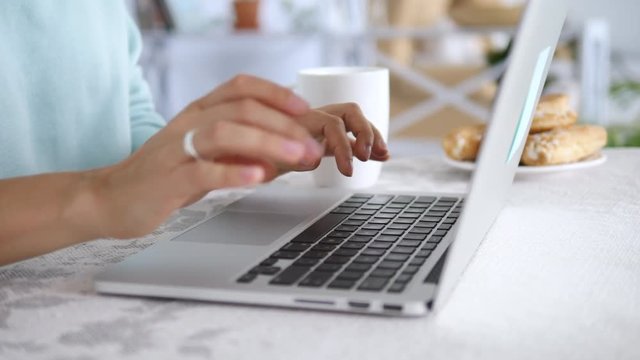 Close-Up Woman Hands Working On Laptop At Table At Home