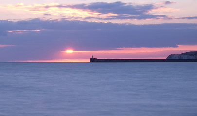 newhaven lighthouse and harbour wall at sunset