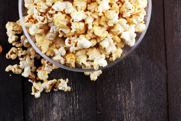Cinema concept with popcorn on rustic table