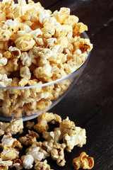 Cinema concept with popcorn on rustic table