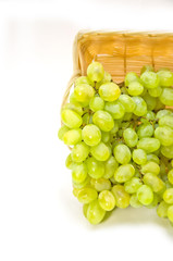 green grapes in basket on white background selective focus