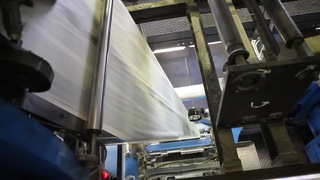 Video clip from the printing factory. Kilometers of newspapers. Printing machines in operation.
