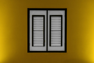 Yellow wall with a window in the center