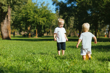 Naklejka premium Family. Cute nice brothers feeling good while playing together in the garden