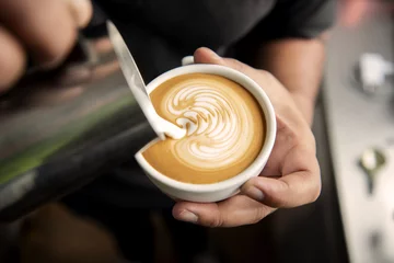 Wandcirkels plexiglas Barista making coffee latte art or Cappuccino in coffee shop. © NaMong Productions
