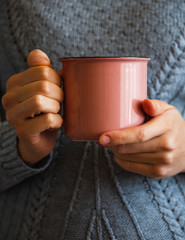 Women in Sweater holding cup of Hot Coffee, Chocolate or Tea. Concept Autumn Comfort, Morning Drinking.