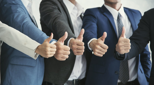 group businesspeople thumbs up together. concept teamwork and success.
