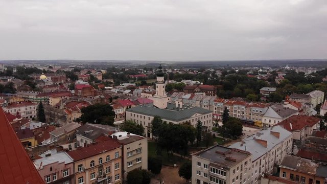 Aerial view of downtown of Drohobych city, Ukraine. Flight from the church St. Bartholomew in direction to the city hall. Architecture, city hall, central square, panoramic view of city