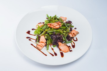 salad with salmon and asparagus on a white plate
