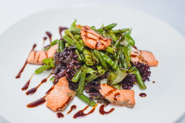 salad with salmon and asparagus on a white plate