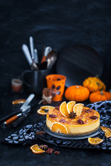 Delicious pumpkin and orange cheesecake decorated with caramel sauce and pecan