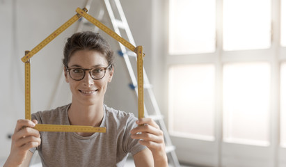 Woman making a house shape with a folding ruler