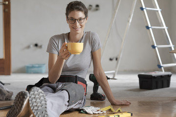 Woman doing a home renovation and having a coffee break