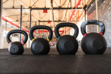 Row of kettlebell or girya weights in a gym weight in a fitness and active healthy lifestyle concept
