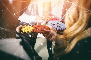 Business team connect pieces of gears. Teamwork, partnership and integration concept. double...