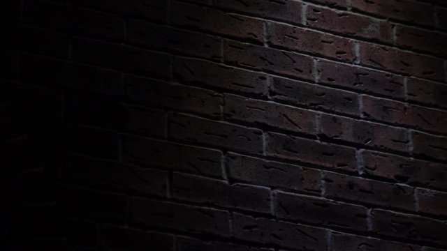 Pan of brick wall night noir lighting