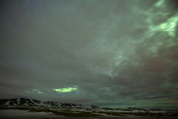 Fototapeta premium The northern lights pierce the clouds