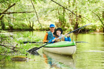 Kayaking on river in forest. Family on canoe. Active recreation and vacation