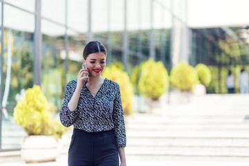 Business woman talking on the phone outside