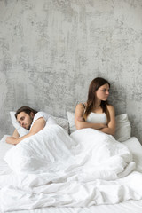 Offended couple ignore talking after fight or quarrel, having relationship issues lying separately in bed, upset lovers avoid having sex, spouses each other consider break up or divorce, not forgiving