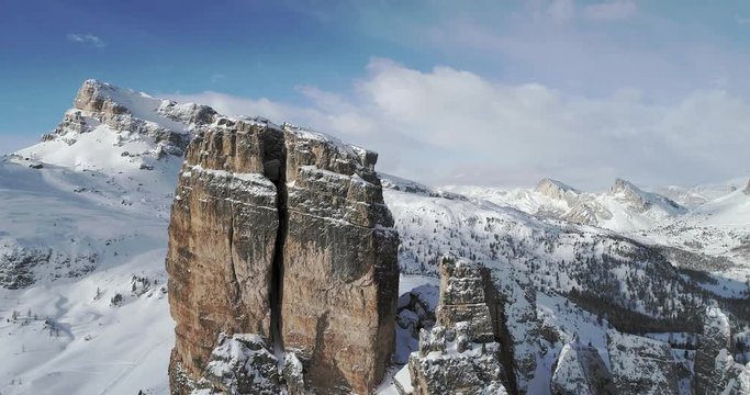 Forward aerial toward majestic Cinque Torri mounts showing steep rocky cliff. Sunny day with cloudy sky.Winter Dolomites Italian Alps mountains outdoor nature establisher.4k drone flight