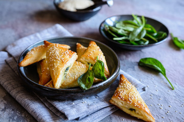 Spanakopita triangles stuffed with spinach and Feta cheese