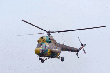 Fototapeta premium The helicopter is in the air. Helicopter in motion around it is dust.